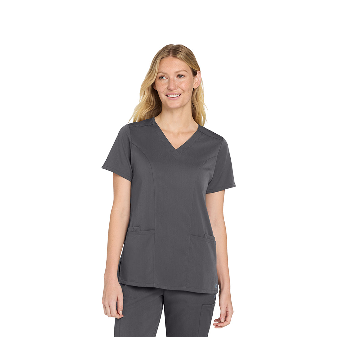 Woman wearing a gray scrub top on a white background