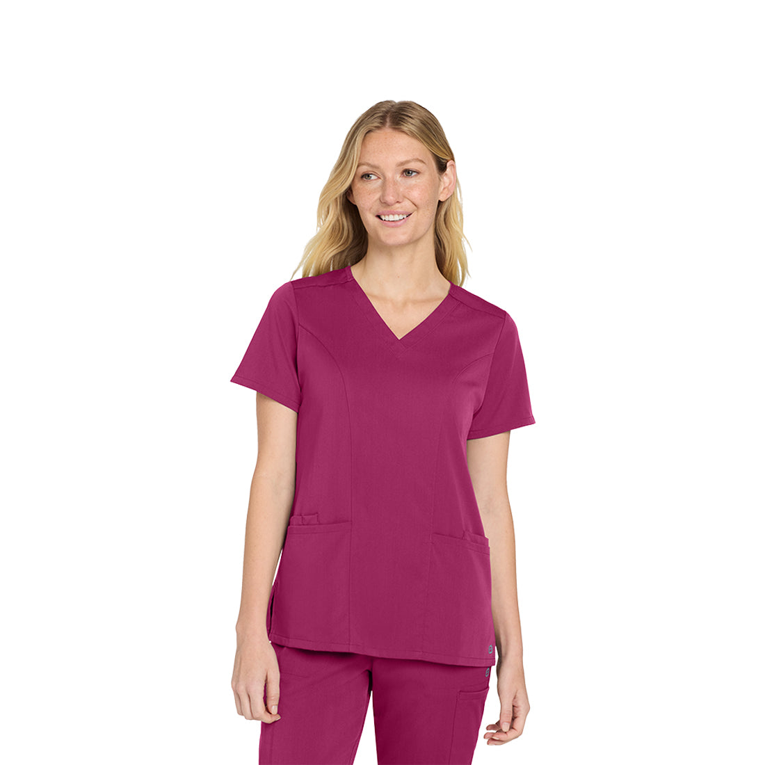 Woman wearing a wine scrub top on a white background