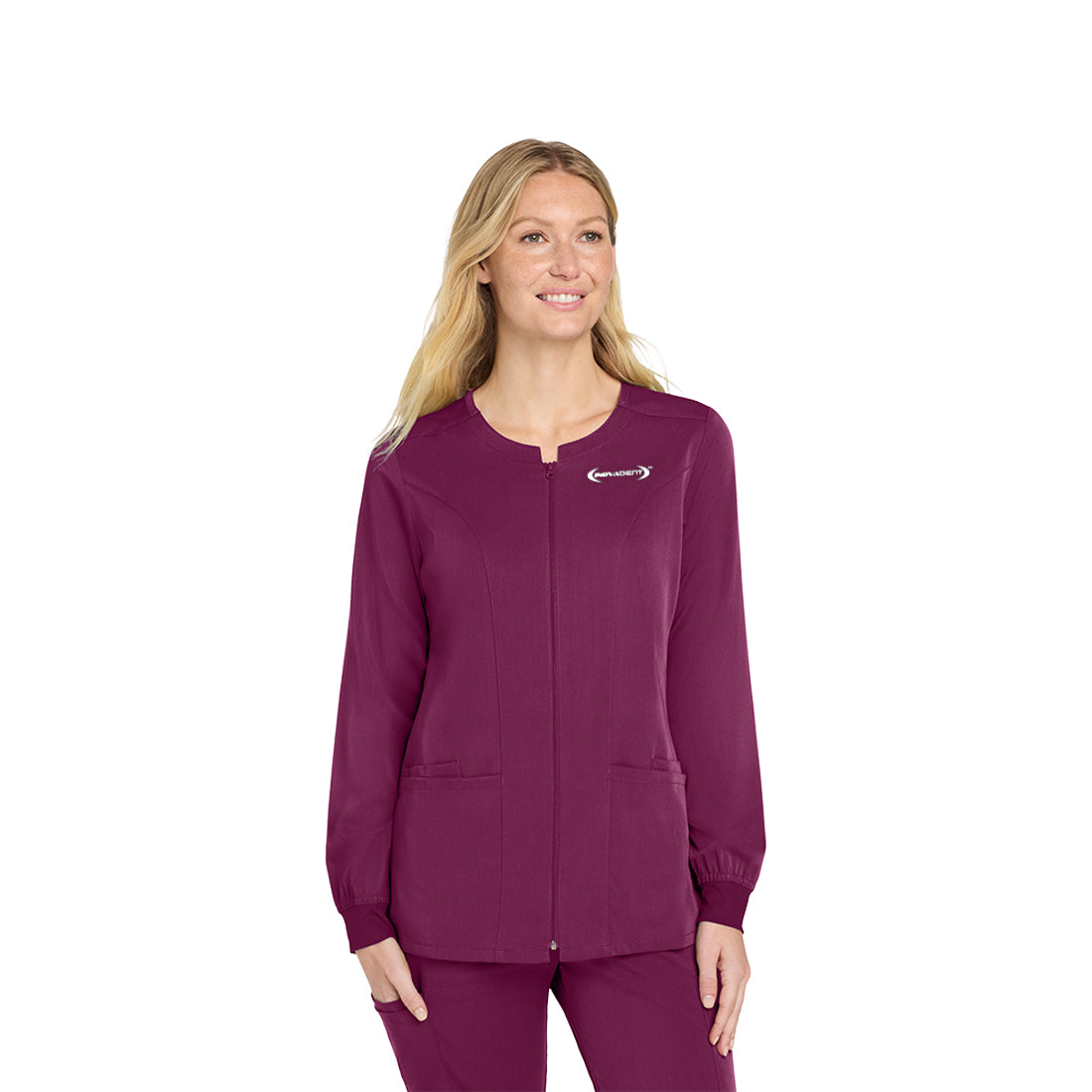 Woman wearing a wine scrub top on a white background