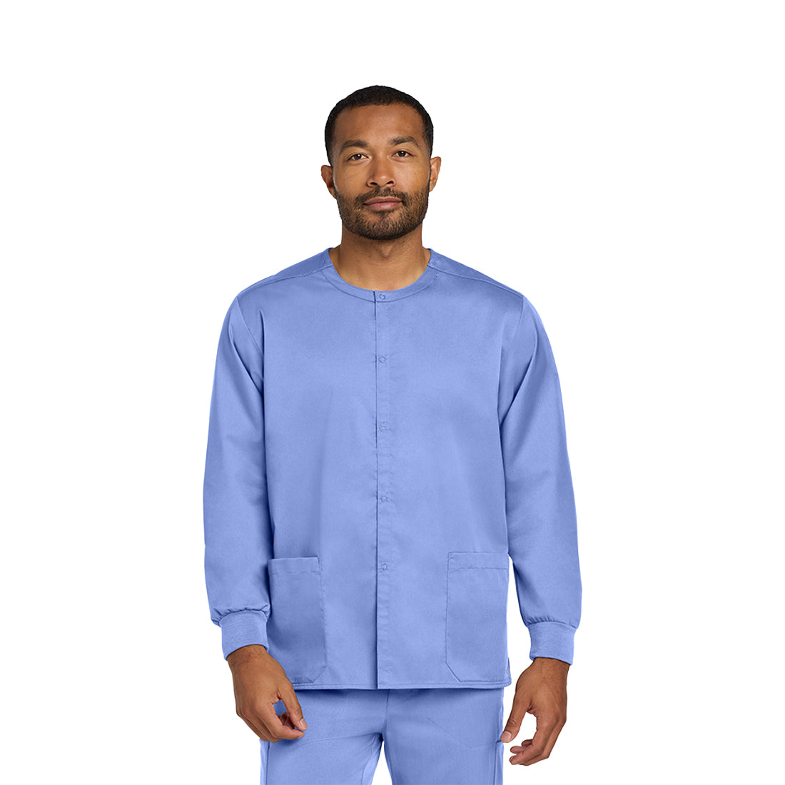 Man wearing a light blue scrub set on a white background