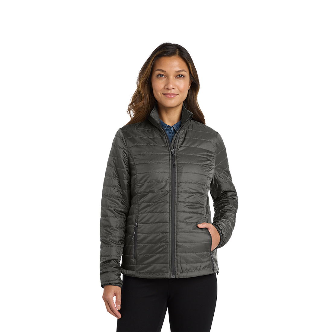 Woman in a grey puffy jacket on a white background