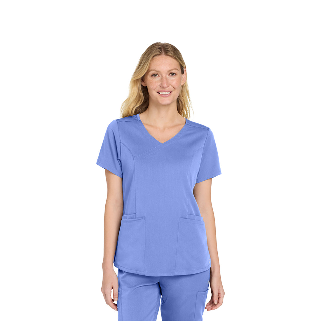 Woman wearing a blue scrub top on a white background
