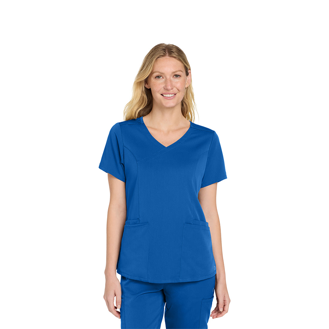 Woman wearing a blue scrub top and pants on a white background