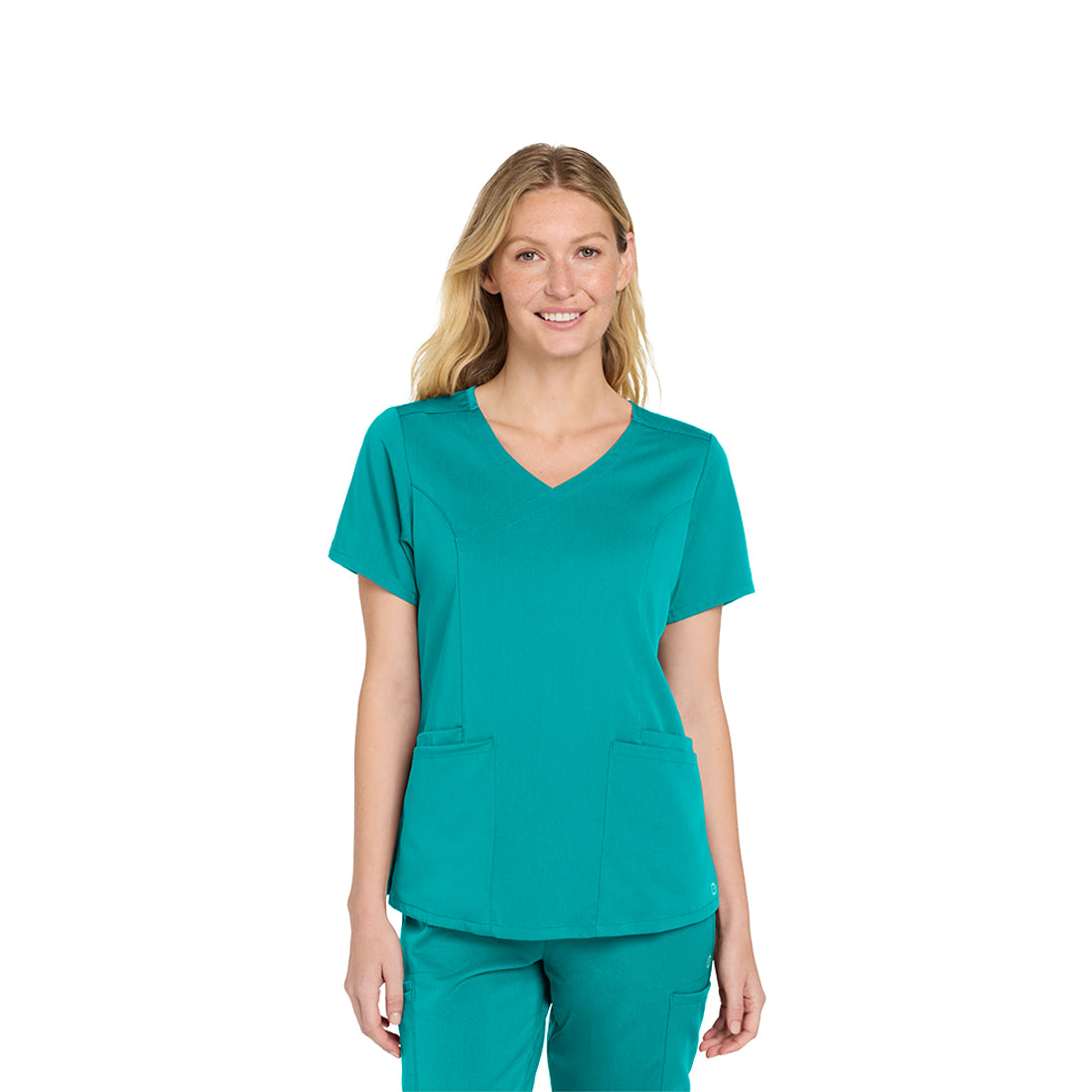 Woman wearing a teal scrub top and pants on a white background