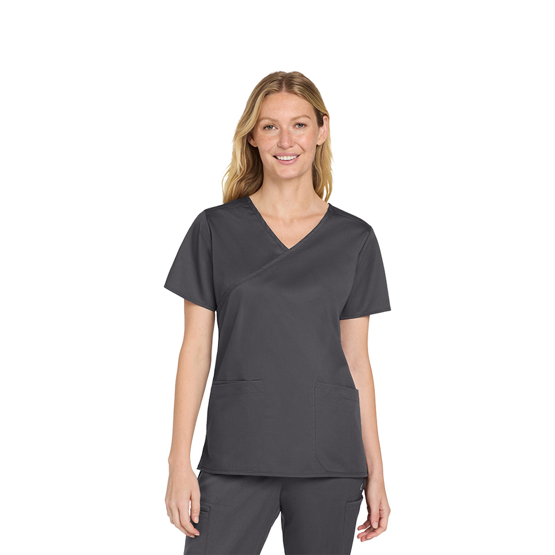 Woman wearing a gray scrub set on a white background